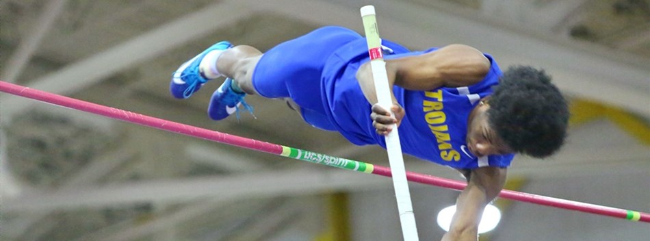 A male pole vaulter sails over the crossbar during the 2019 Class 4A State Indoor Track Meet.